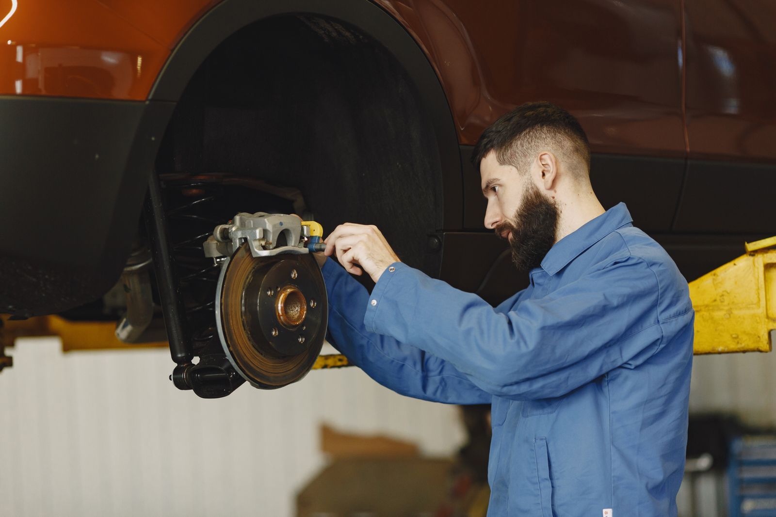 A technician working on a brake at the wheel