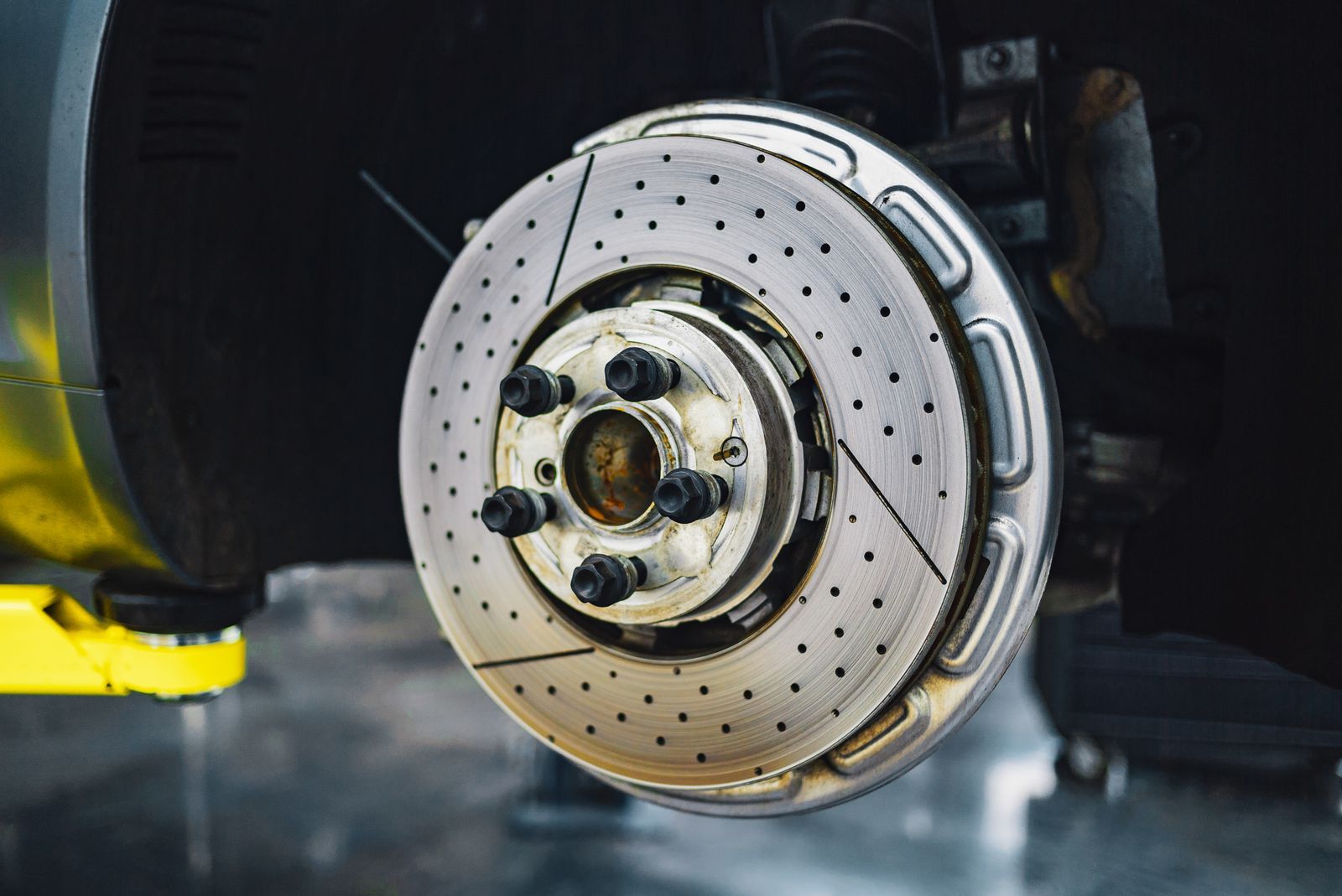 A drilled brake rotor on a lifted car
