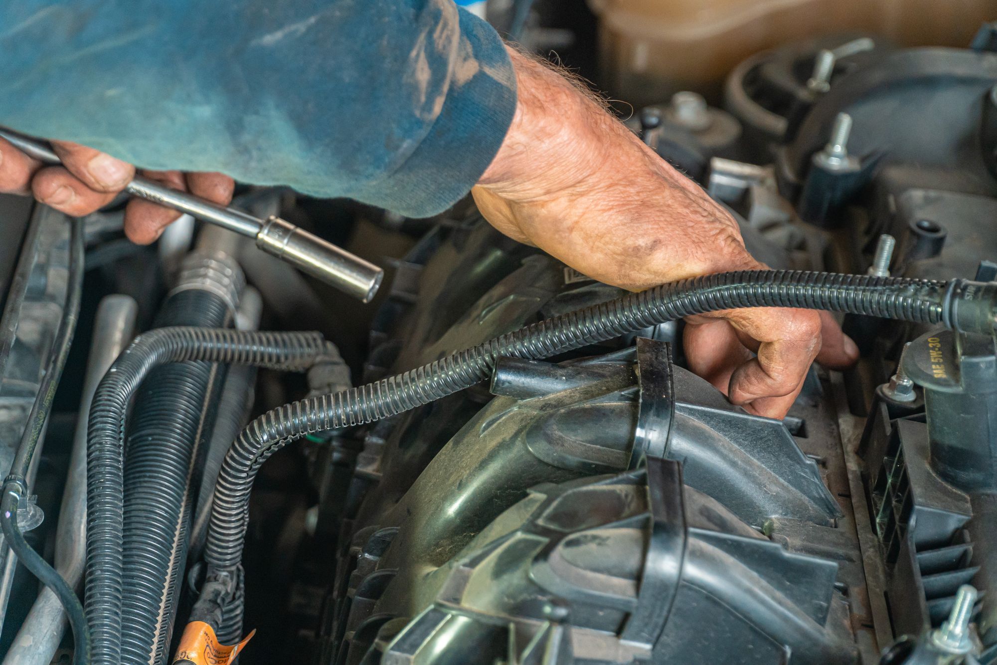 Hands working on an engine