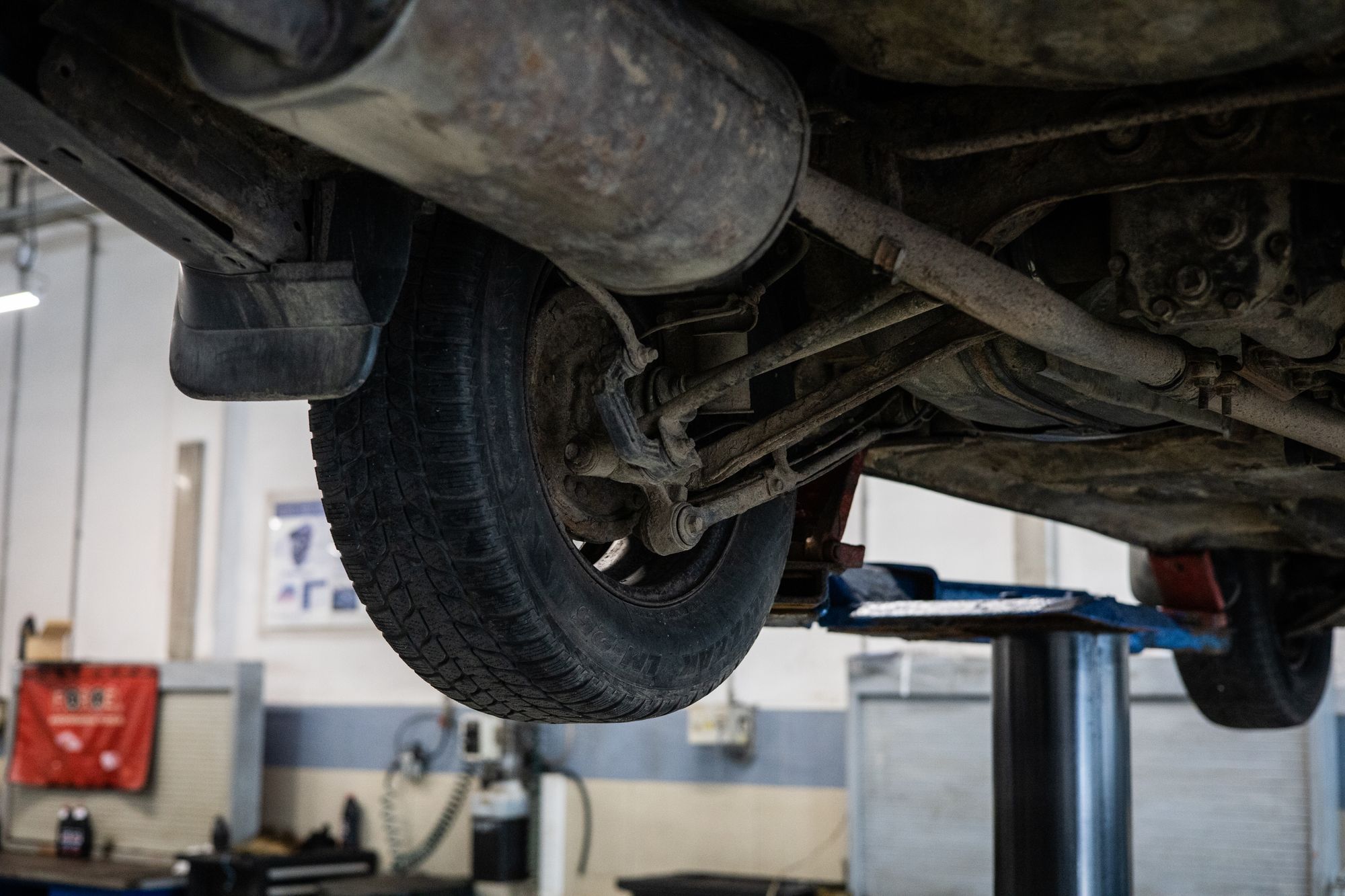 The underside of a car on a lift