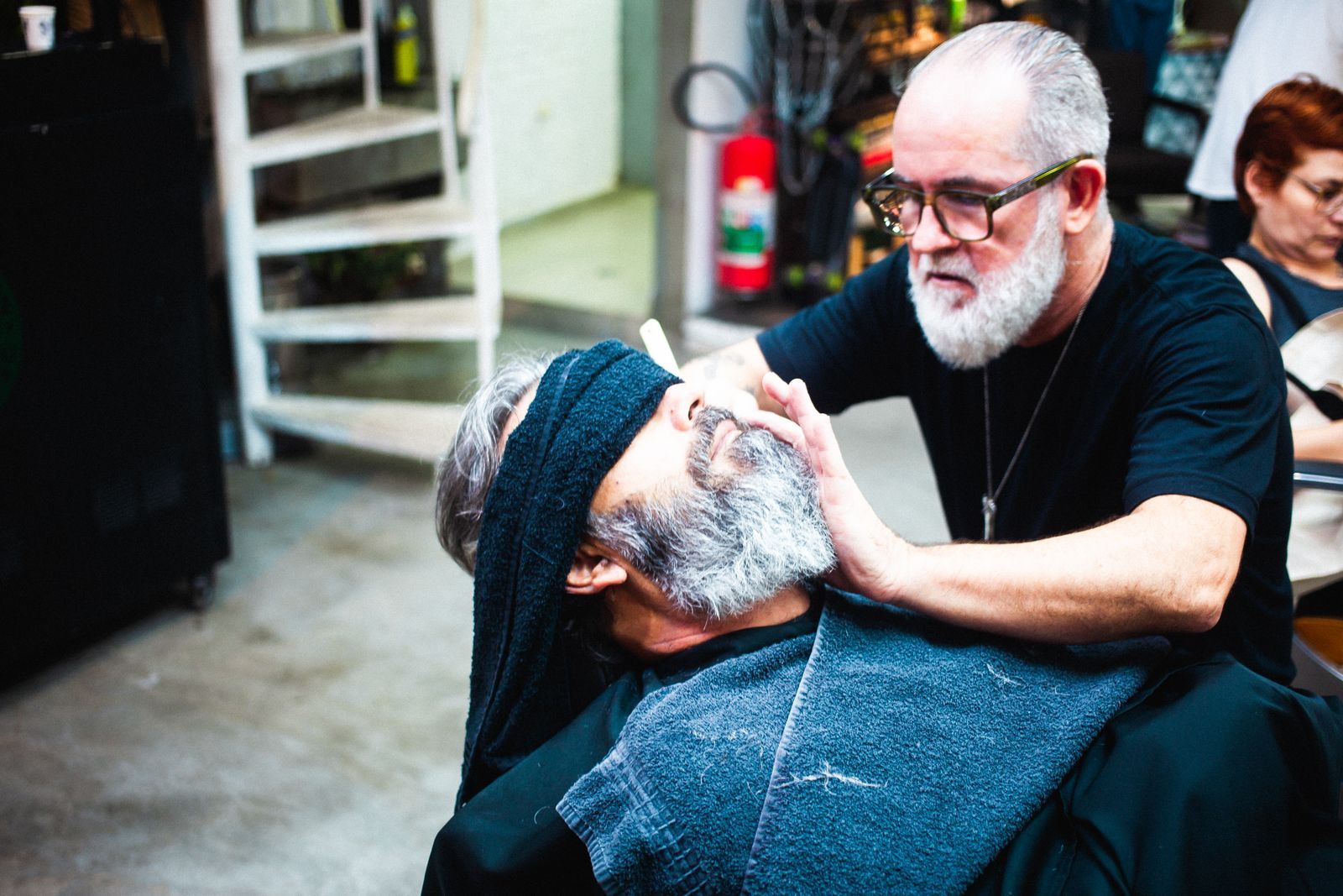 An older client getting a beard trim