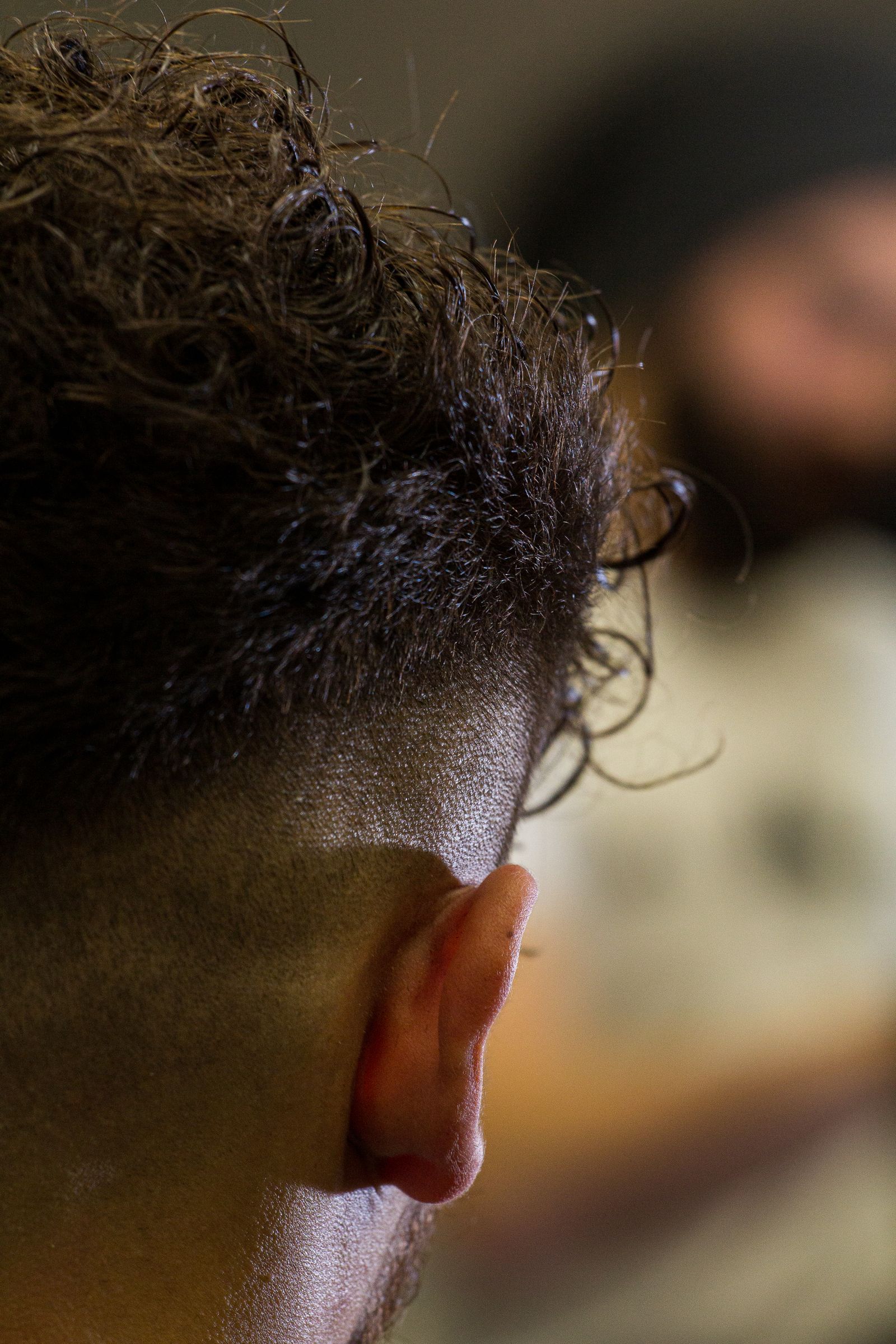 Curly hair on top with a tight fade