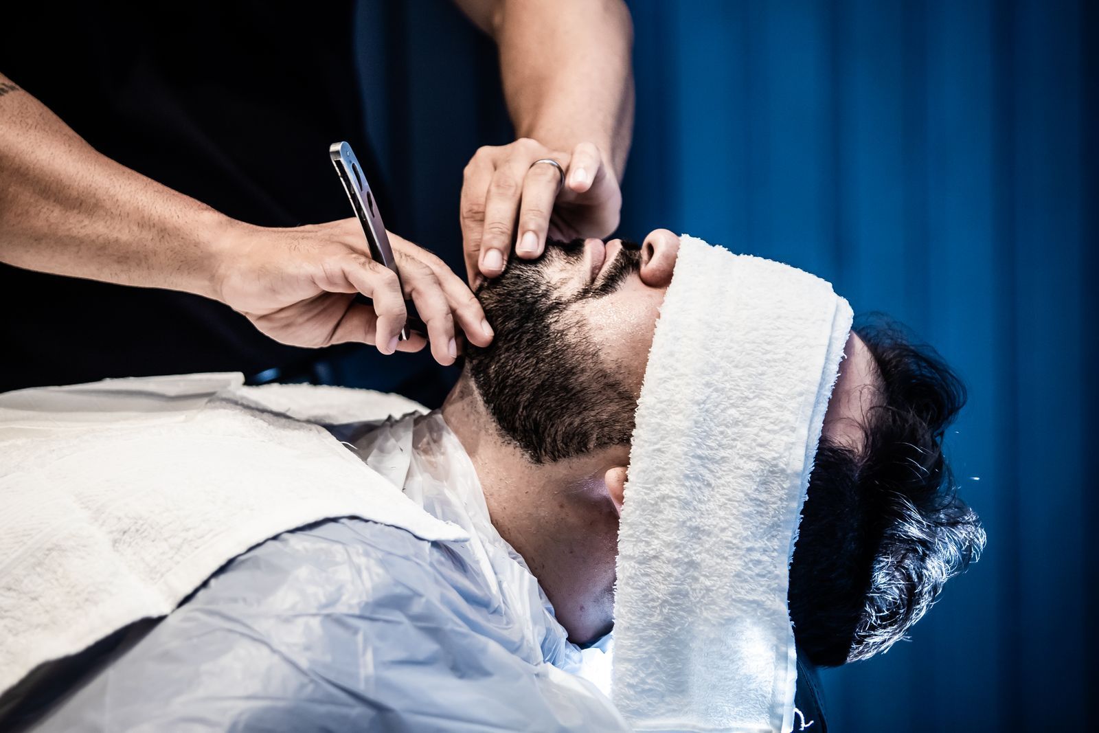 A straight razor shave with a towel