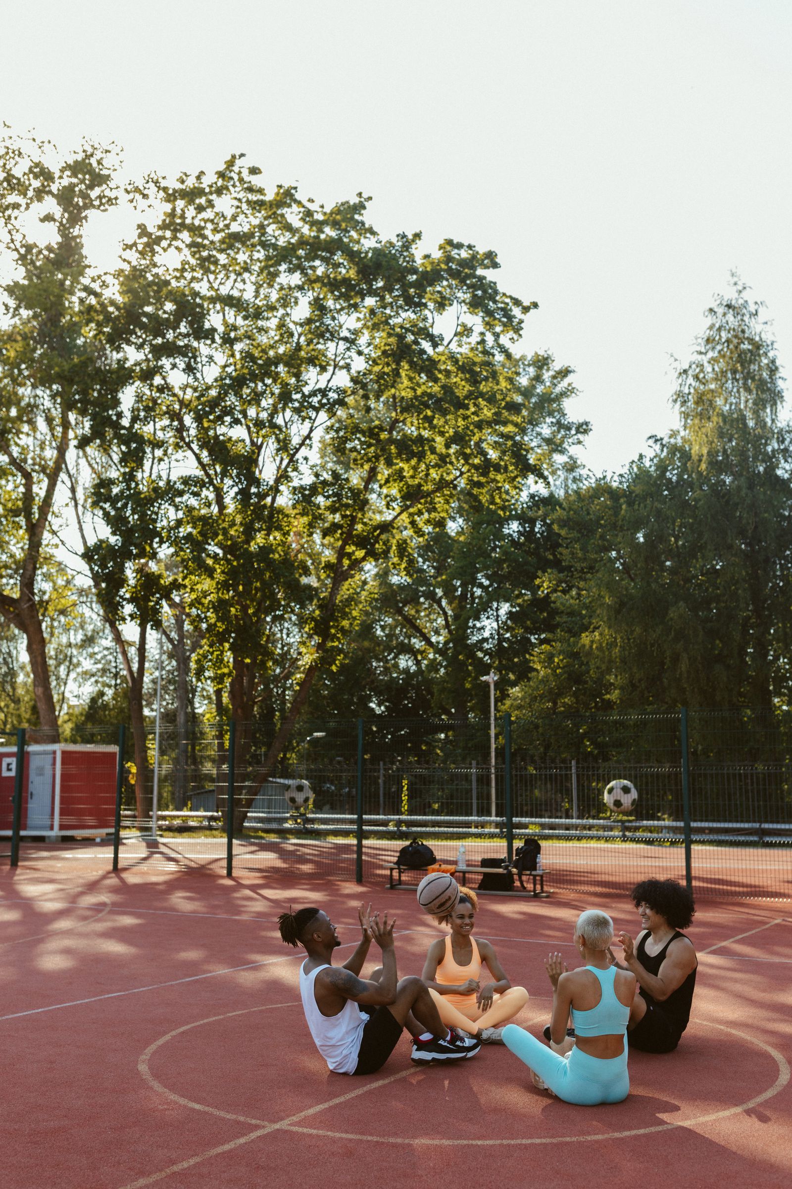 A group in a circle on an indoor court