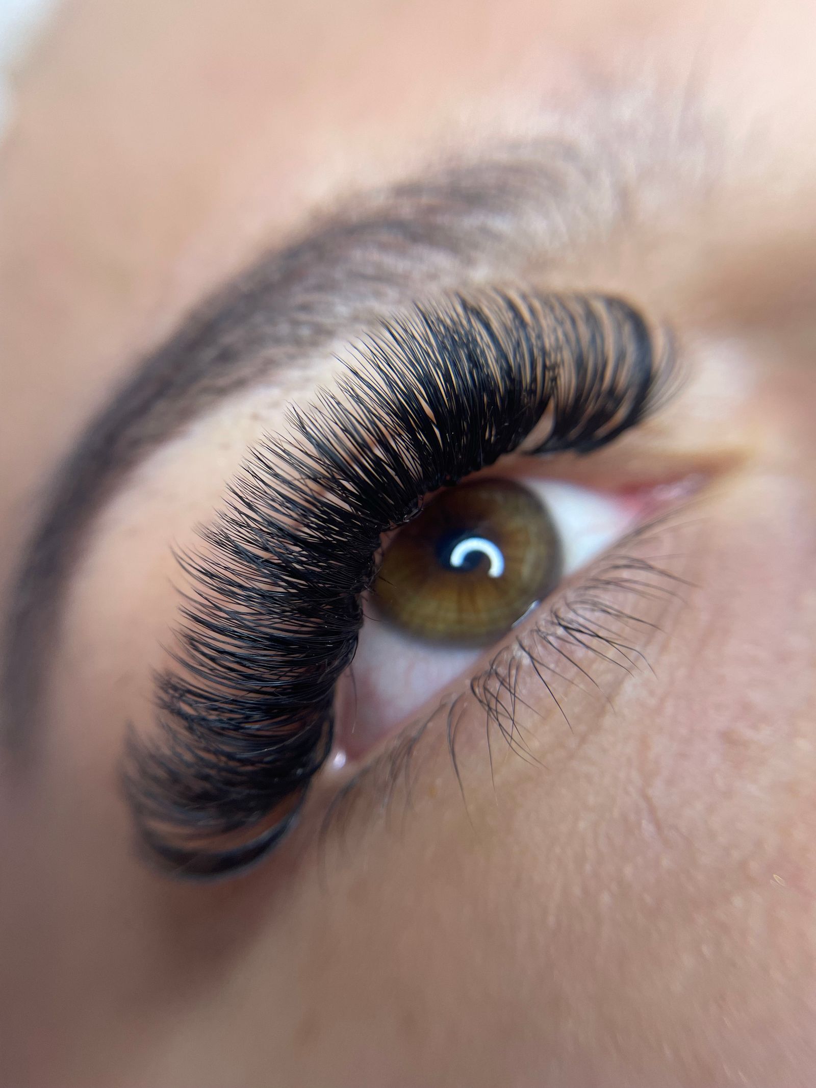 Close-up of an eye with full, dark volume lash extensions