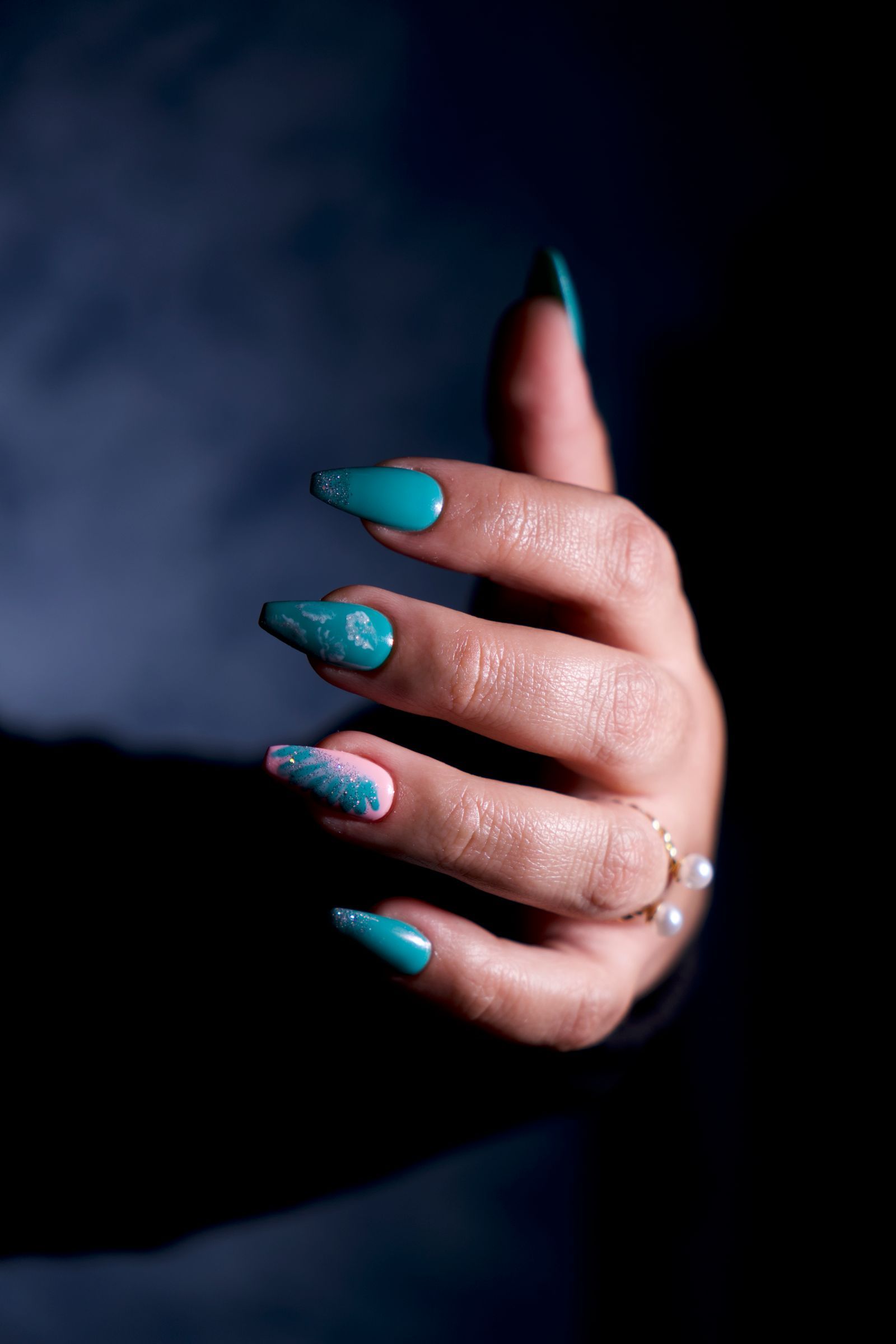 Long turquoise nails with a hand-painted accent nail