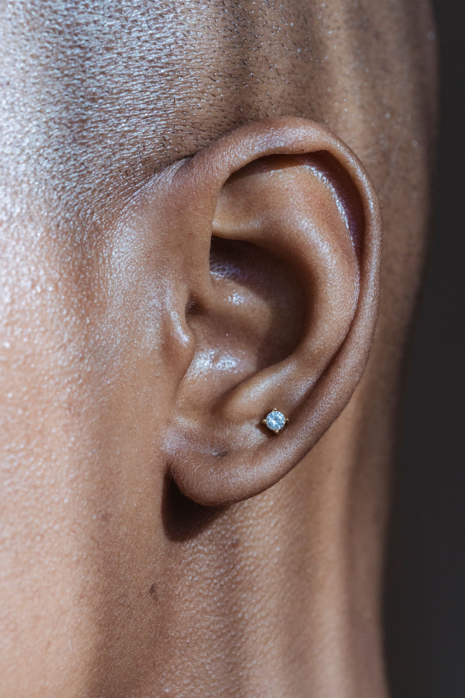 Close-up of a small clear stone stud in a lobe