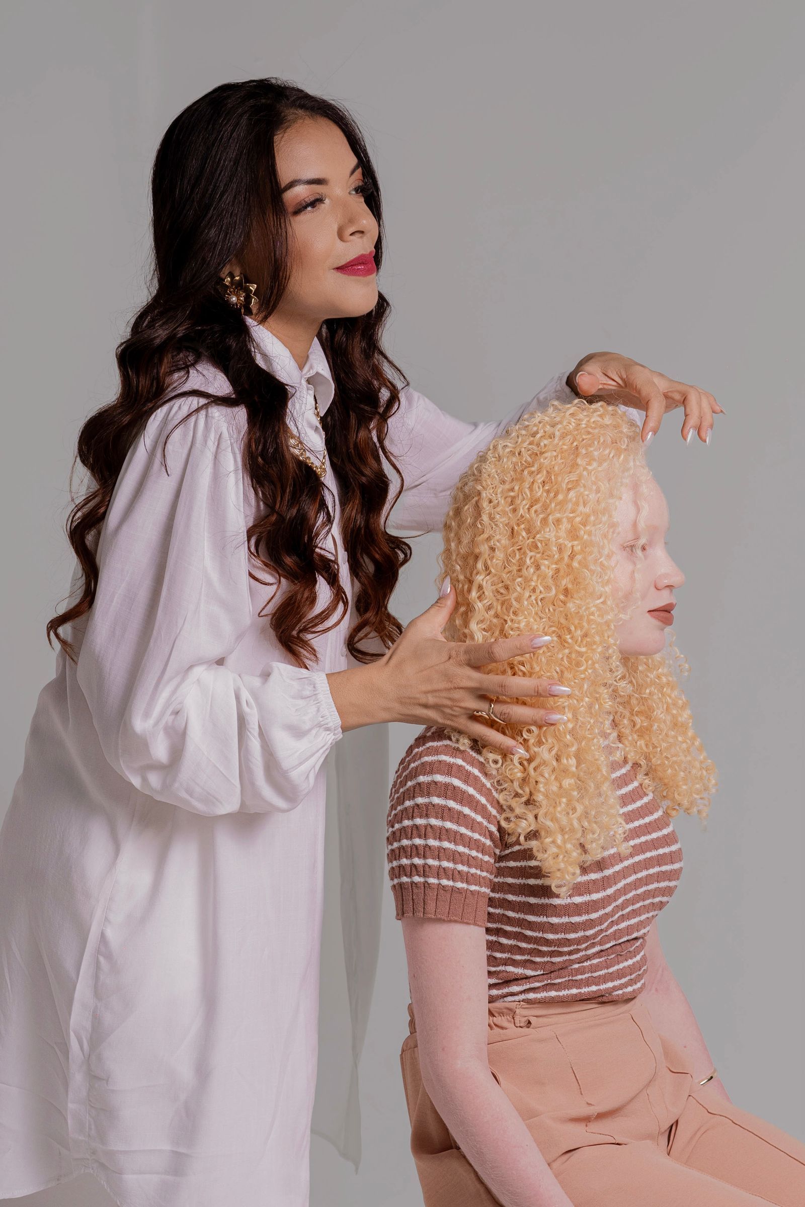 A stylist shaping curls in the salon