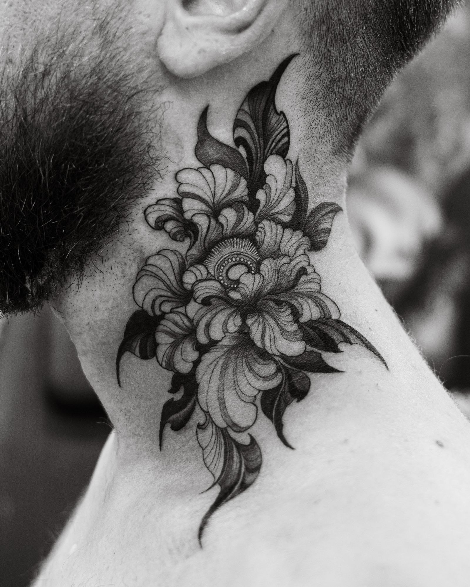 Ornamental black floral piece on a neck