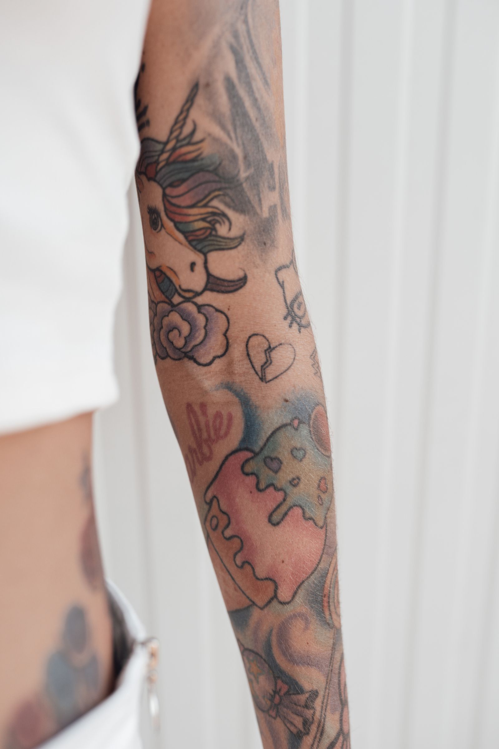 A forearm covered in vivid colour flowers