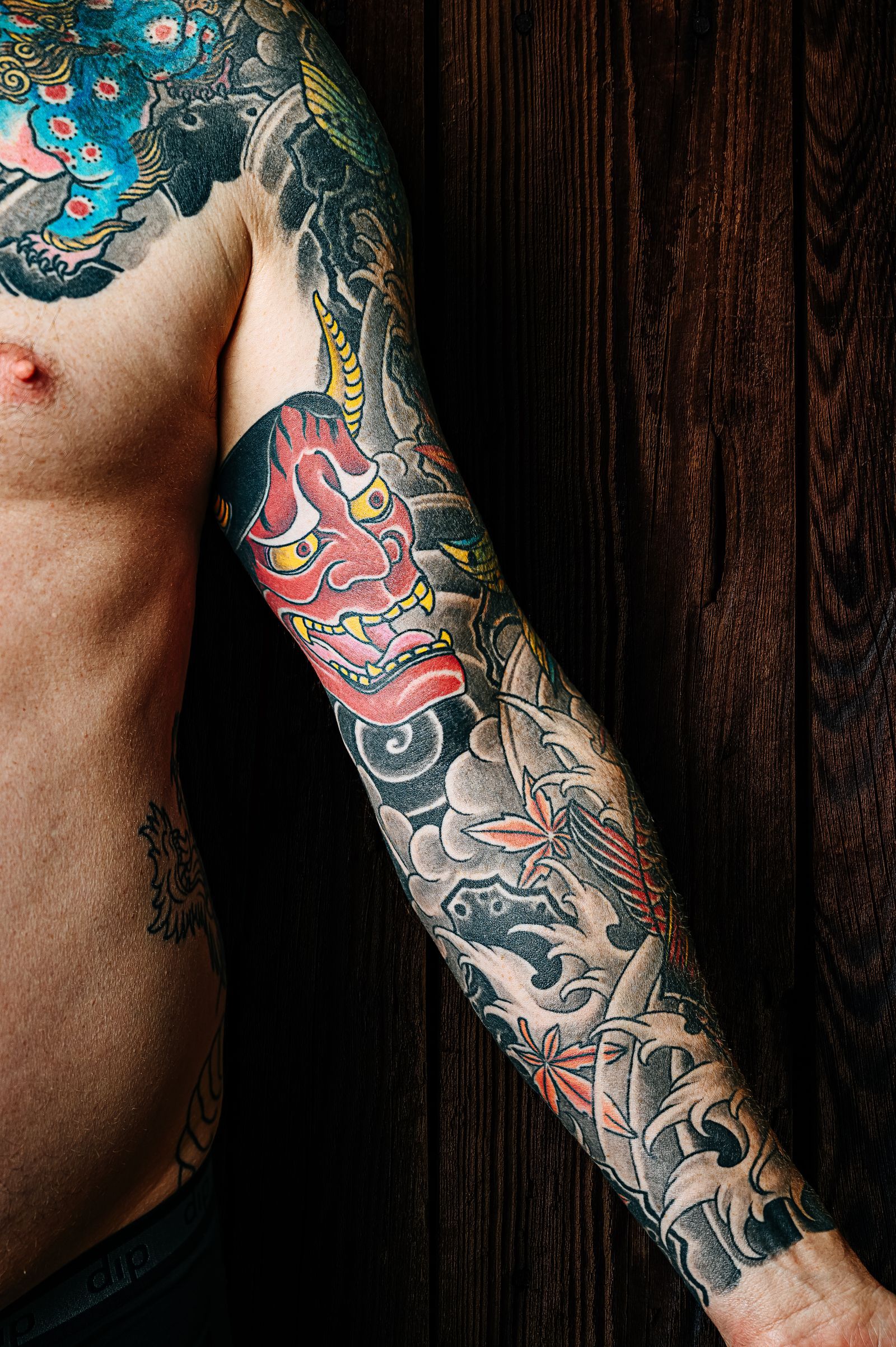 A full arm sleeve in bold colour with a red mask and black wind bars
