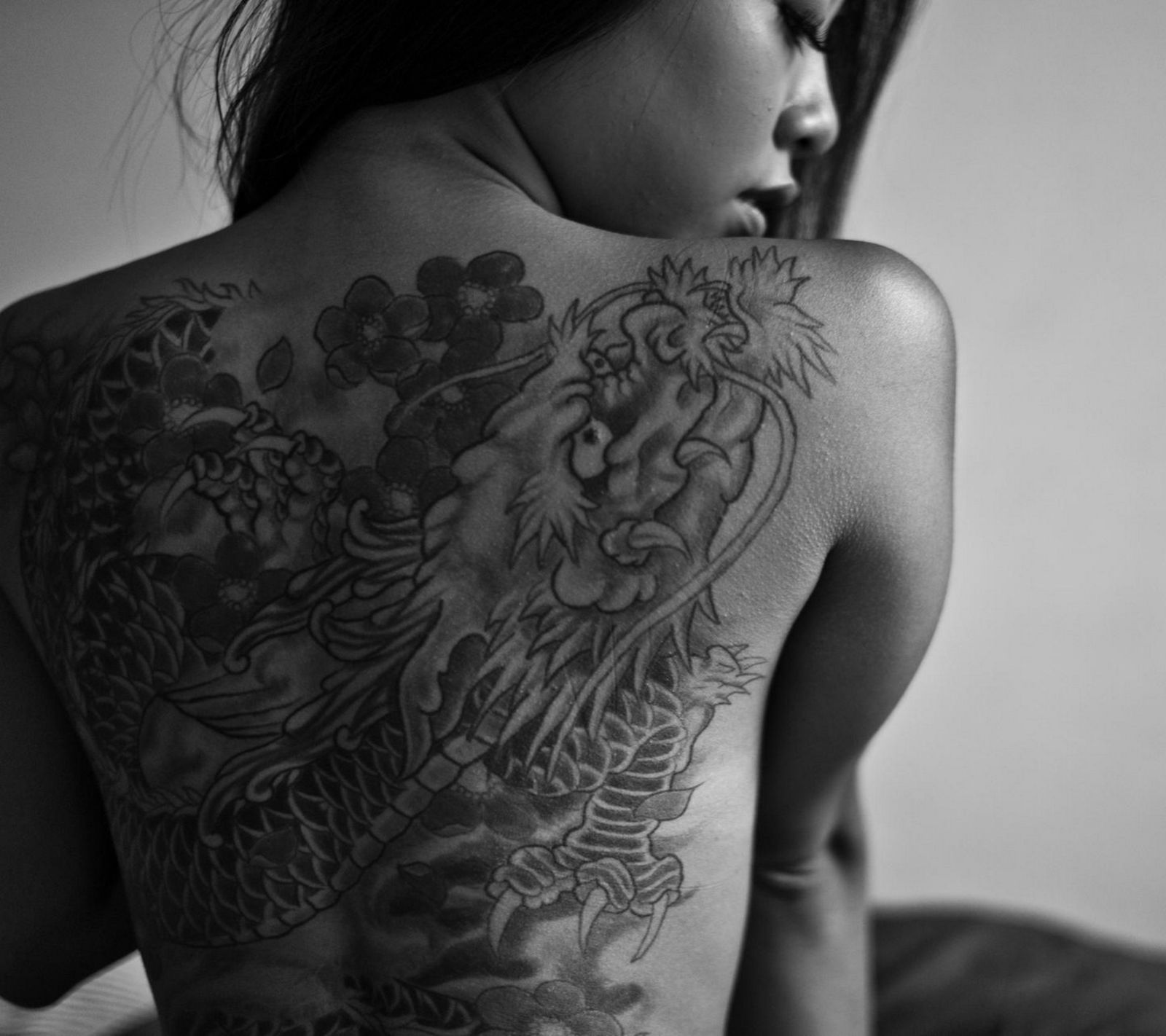 Black and grey Japanese back piece with a dragon and cherry blossoms