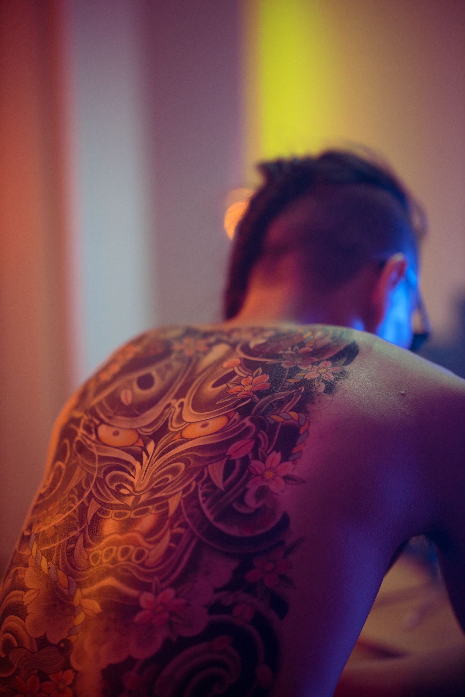 A full colour Japanese back piece under warm studio light