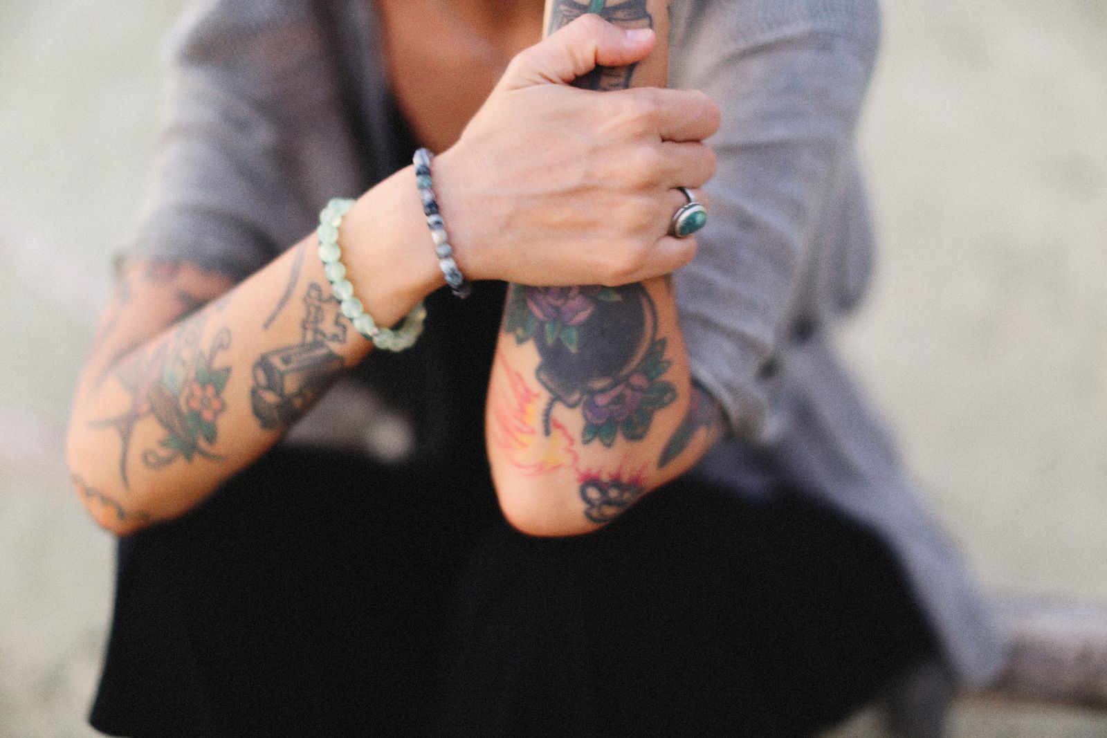 Tattooed arms with bracelets